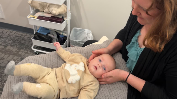 Dr. Andrea performing a gentle infant neck evaluation at Rising Sun Chiropractic in St. Peter MN